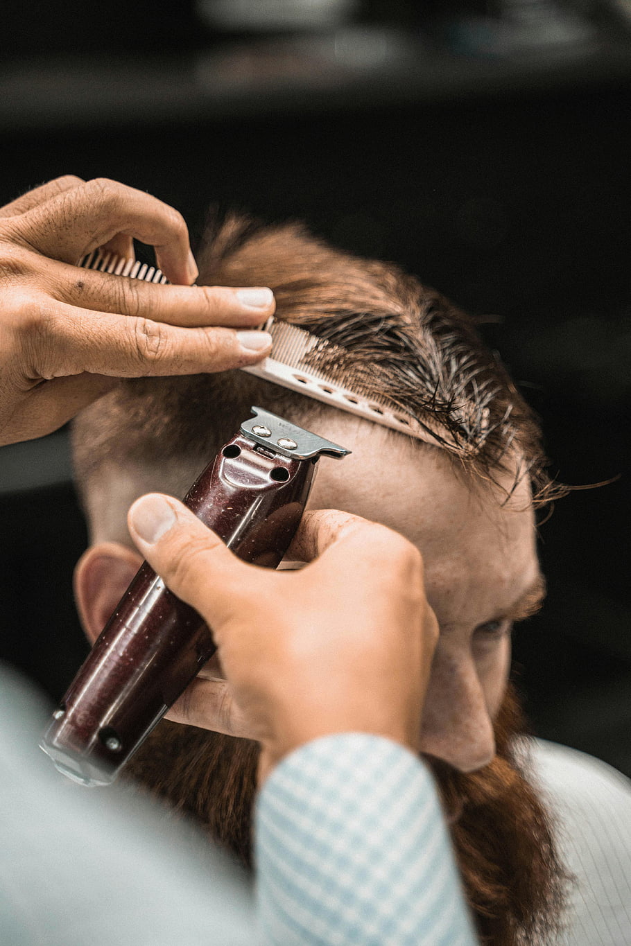 Barber working a fade with clippers